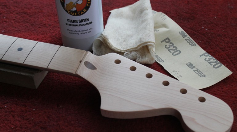 Preparing the neck by sanding and sealing with clear lacquer