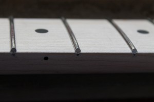 The fret ends are beveled to 30 degrees from vertical