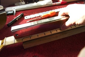 Using a sanding bar to level the frets