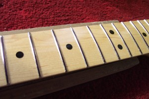 Marker pen on the fret tops will highlight low spots