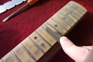 Re-crowning the frets using a crowning file